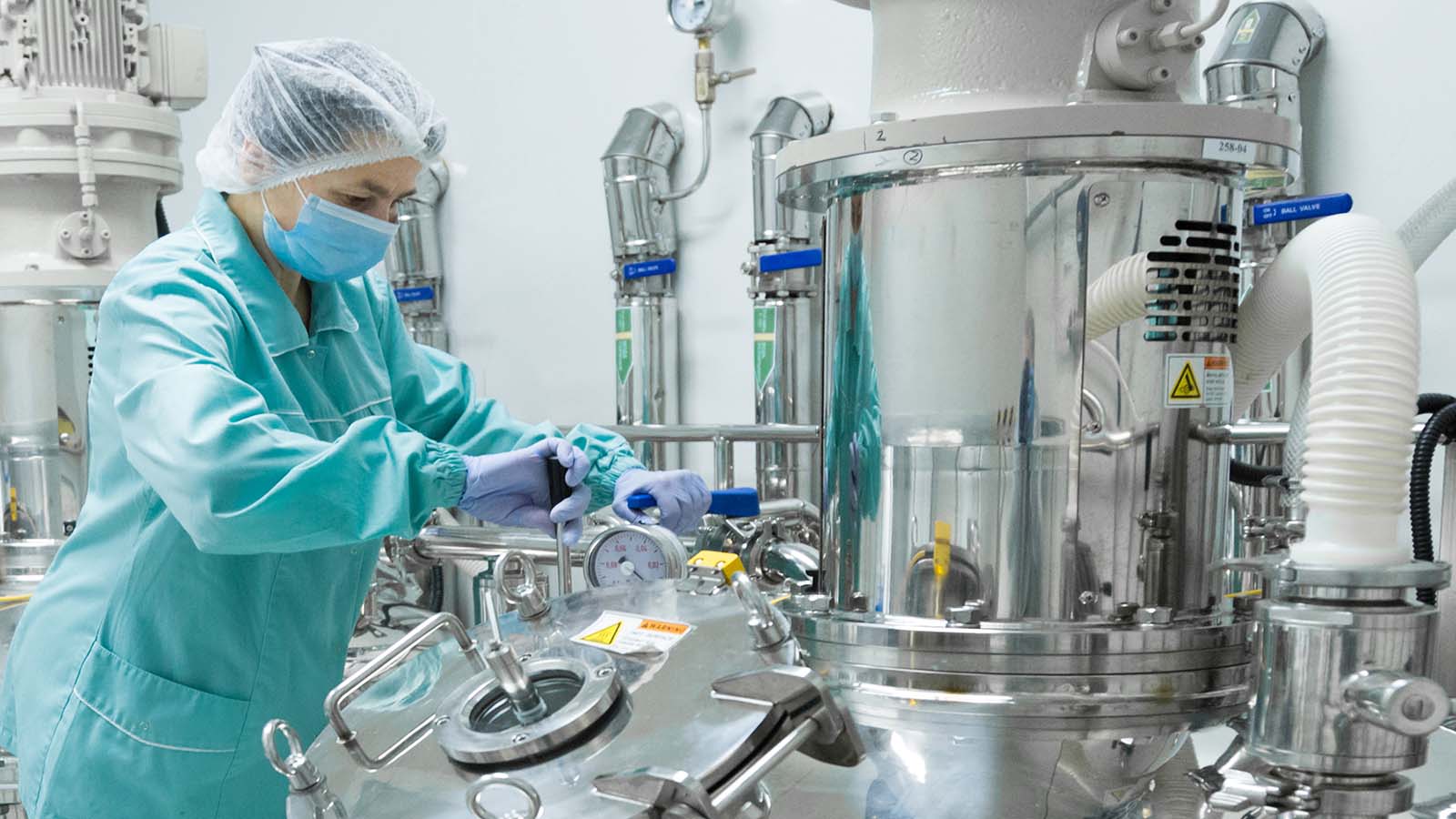 Pharmaceutical,Factory,Woman,Worker,In,Protective,Clothing,Operating,Production,Line